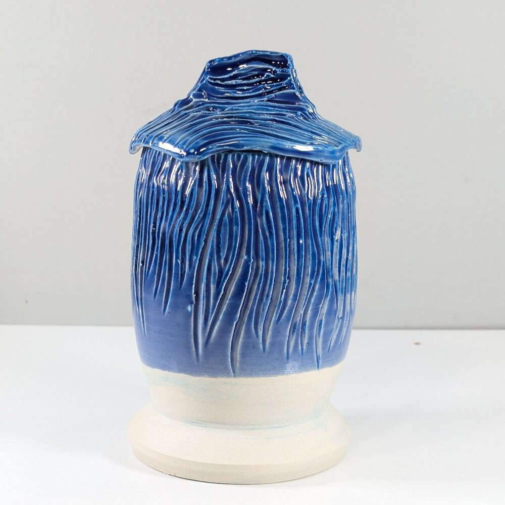 Handmade carved pottery storage jar in blue and white